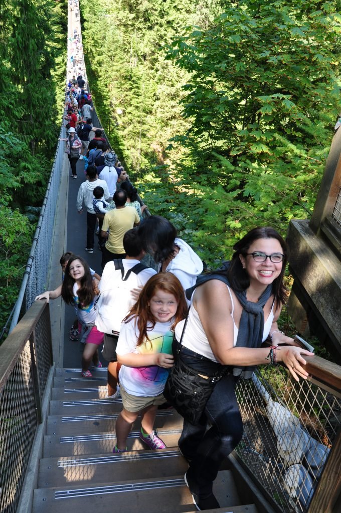 Family walking across Capilano Suspension Bridge in North Vancouver, Canada
