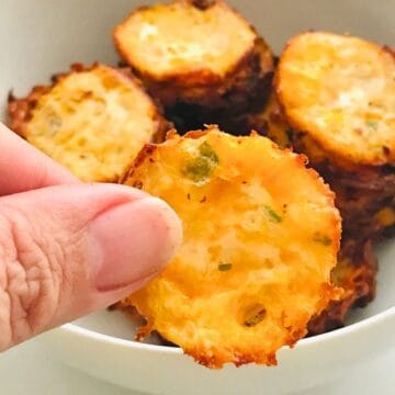 Crispy savory potato bites with green herbs, ideal for pet gourmet treats and healthy snacks from Petit Gourmet.