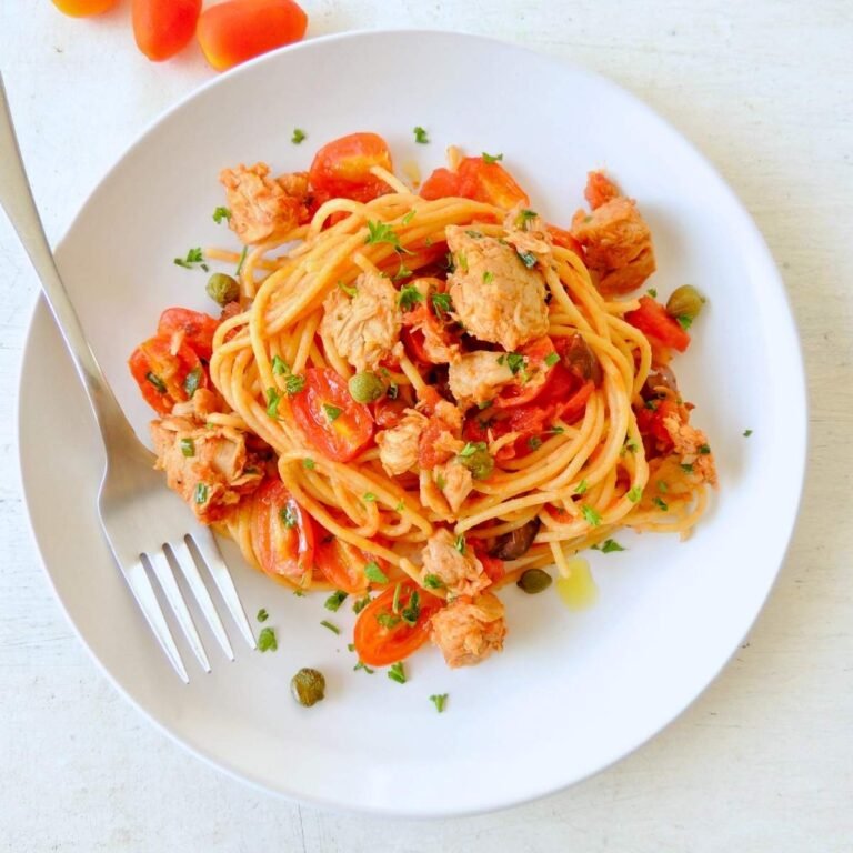 High-protein Dominican tuna sofrito pasta in bowl with fresh tomatoes and cilantro